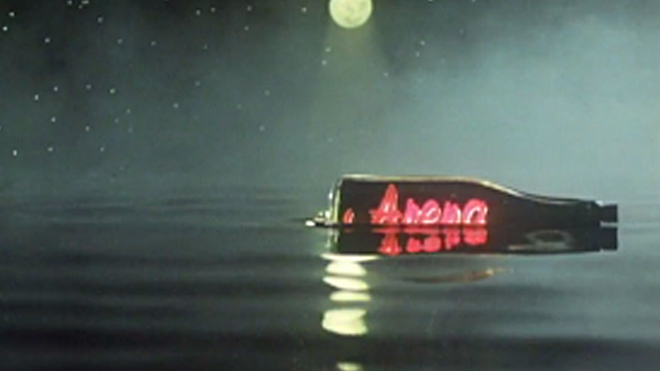The Arena title sequence featured a floating neon in a bottle accompanied by a repetitive guitar track by Brian Eno